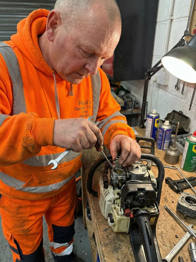 Experienced technician repairing garden machinery